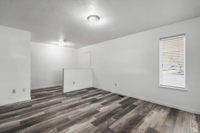 486 13th St, Ogden, UT 84404 - empty room featuring baseboards, a textured ceiling, and dark wood-style floors