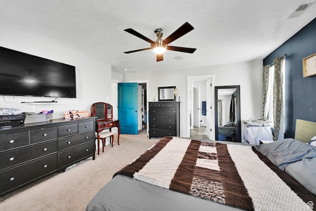 carpeted bedroom with visible vents and a ceiling fan