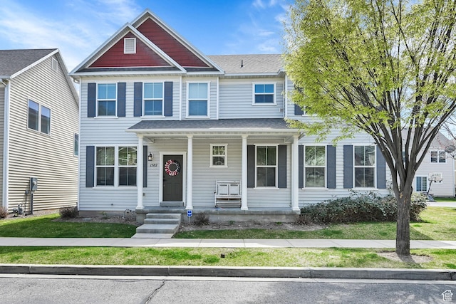 view of front facade featuring a front lawn and covered porch