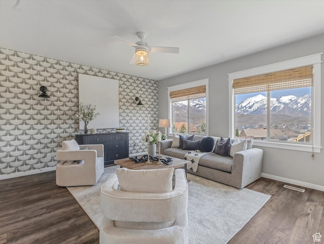 14939 S Winged Bluff Ln, Draper, UT 84020 - living room with baseboards, a ceiling fan, an accent wall, and wood finished floors