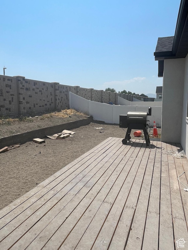 deck with a fenced backyard