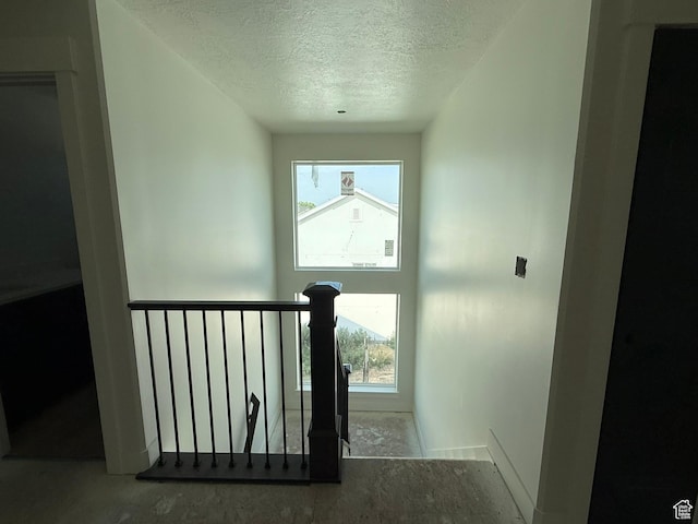 2405 W 3200 N, Farr West, UT 84404 - staircase with a textured ceiling, healthy amount of natural light, and unfinished concrete floors
