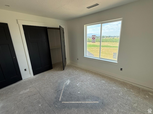 2405 W 3200 N, Farr West, UT 84404 - unfurnished bedroom with a closet and a textured ceiling
