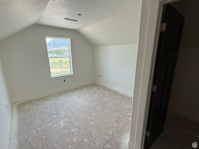 2405 W 3200 N, Farr West, UT 84404 - additional living space featuring a textured ceiling and lofted ceiling