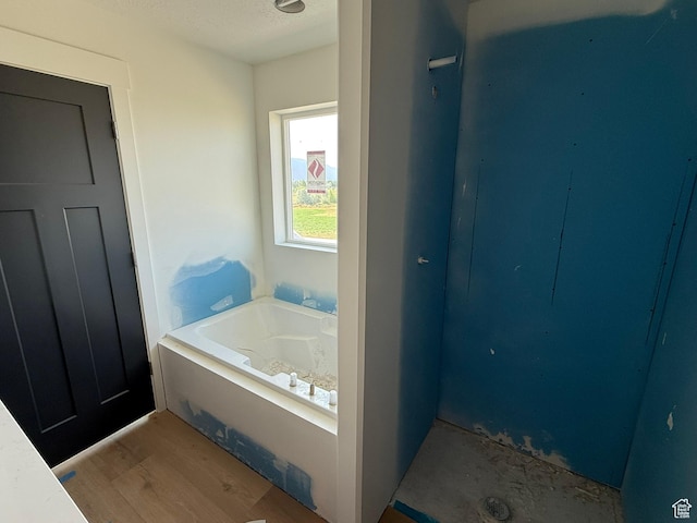 2405 W 3200 N, Farr West, UT 84404 - full bath featuring a bath, wood finished floors, and a textured ceiling