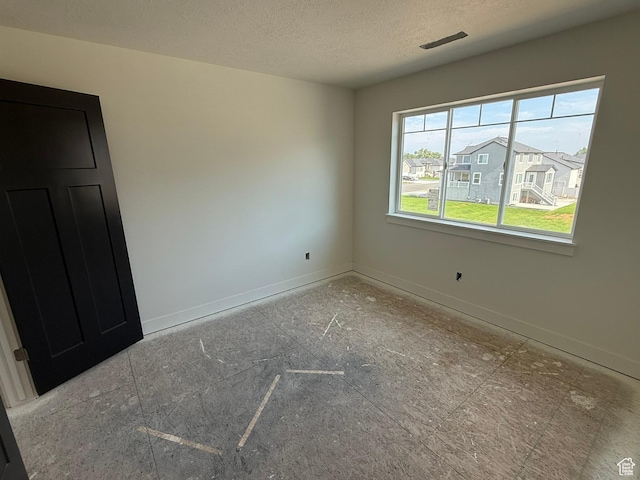 2405 W 3200 N, Farr West, UT 84404 - unfurnished room featuring a textured ceiling and baseboards
