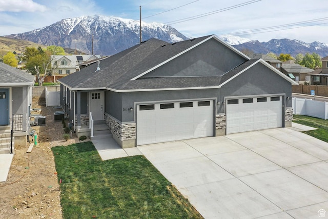 1614 N 160 E Unit 2, Orem, UT 84057 - view of front of home with roof with shingles, stucco siding, driveway, stone siding, and a garage
