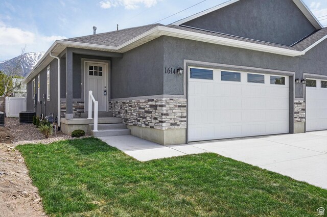 1614 N 160 E Unit 2, Orem, UT 84057 - view of front of home featuring stucco siding, stone siding, an attached garage, a mountain view, and driveway