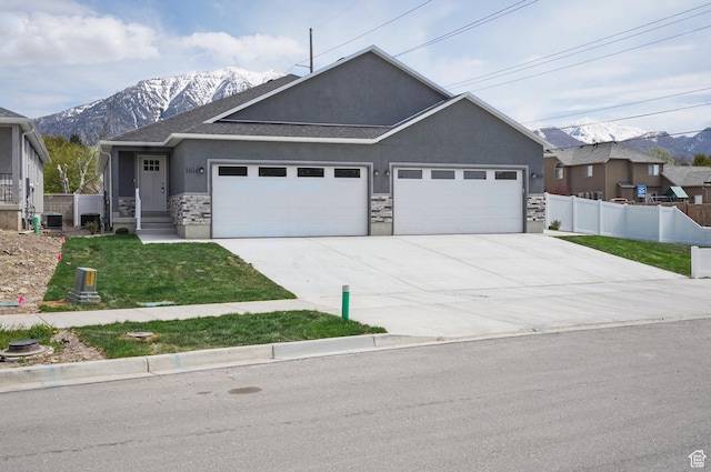 1614 N 160 E Unit 2, Orem, UT 84057 - single story home featuring a mountain view, an attached garage, stone siding, fence, and stucco siding