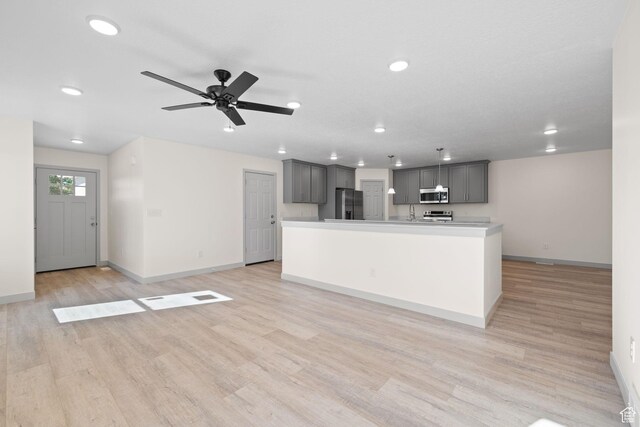 1614 N 160 E Unit 2, Orem, UT 84057 - unfurnished living room featuring baseboards, recessed lighting, and light wood-style floors