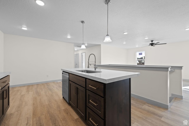 1614 N 160 E Unit 2, Orem, UT 84057 - kitchen with an island with sink, light countertops, stainless steel dishwasher, light wood finished floors, and a sink