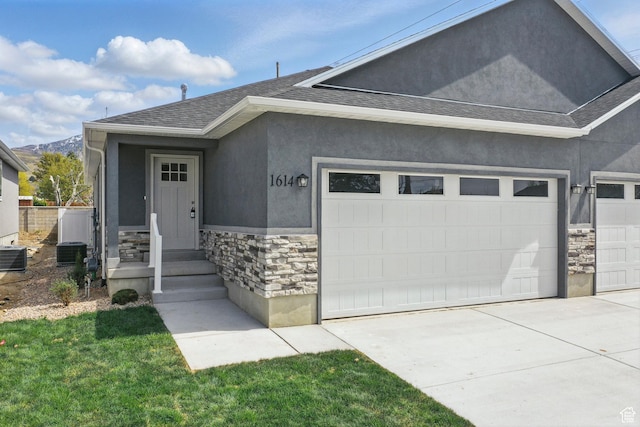 1614 N 160 E Unit 2, Orem, UT 84057 - view of front of property with roof with shingles, stucco siding, driveway, stone siding, and a garage