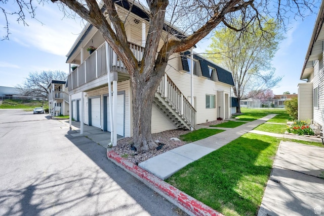4338 S 1100 W Unit 36D, Taylorsville, UT 84123 - view of home's exterior featuring driveway, stairway, a residential view, and a garage