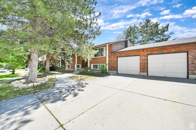 1705 W 4575 S, Roy, UT 84067 - view of front facade featuring driveway, an attached garage, and brick siding