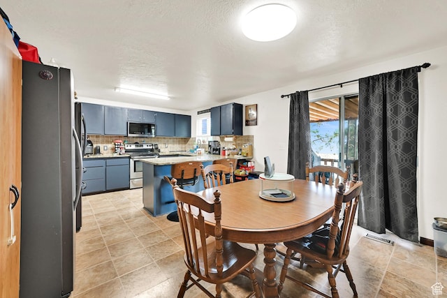 1705 W 4575 S, Roy, UT 84067 - dining room featuring a textured ceiling and light tile patterned floors