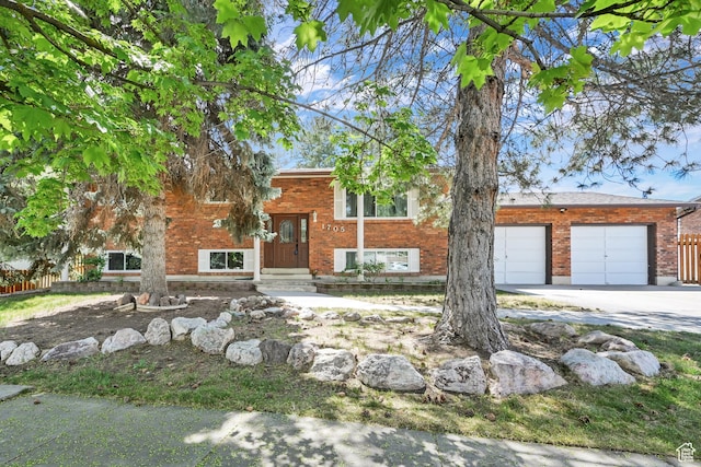 1705 W 4575 S, Roy, UT 84067 - bi-level home featuring concrete driveway, brick siding, and a garage