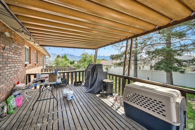 1705 W 4575 S, Roy, UT 84067 - wooden deck with a fenced backyard, a mountain view, and area for grilling