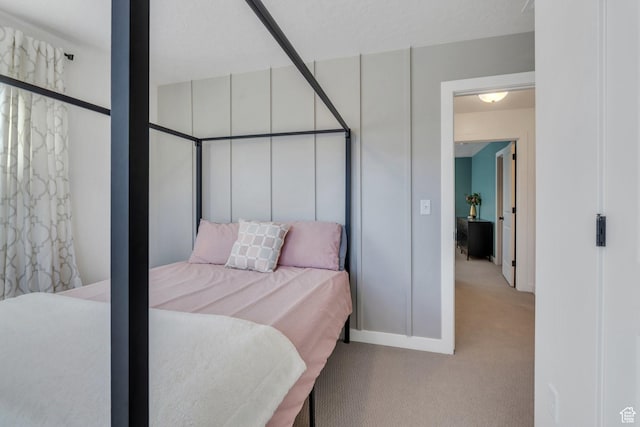 bedroom with baseboards and carpet