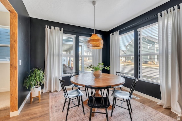 dining room featuring plenty of natural light and light wood-style floors