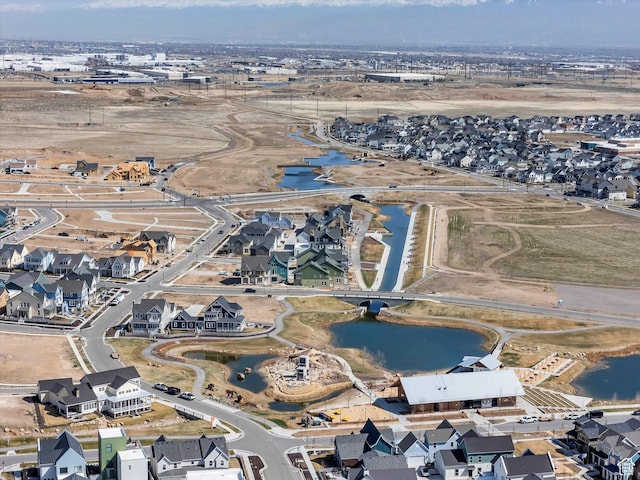 drone / aerial view with a residential view and a water view