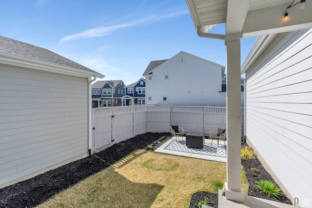 view of yard with a patio, a residential view, fence private yard, and an outdoor fire pit