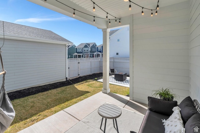 view of patio / terrace featuring an outdoor fire pit, fence, and a residential view
