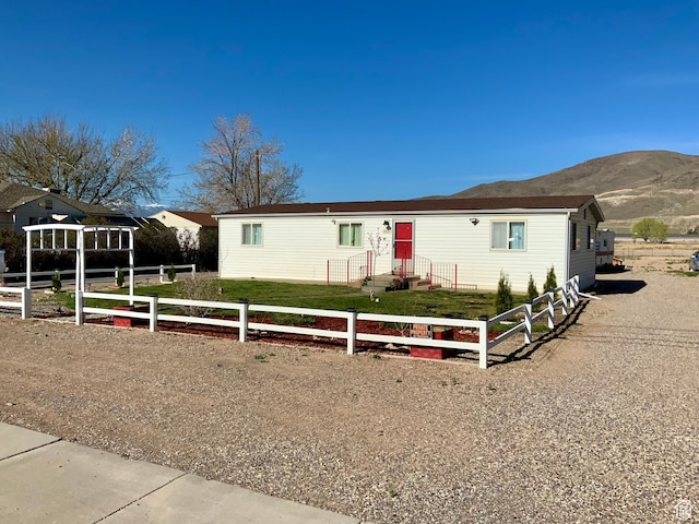 162 S Center St, Elsinore, UT 84724 - manufactured / mobile home with fence, a front yard, and a mountain view