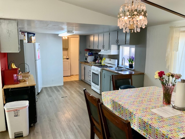 162 S Center St, Elsinore, UT 84724 - kitchen with white appliances, light wood-type flooring, a sink, lofted ceiling, and washer / dryer