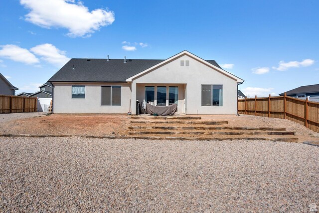 4898 N 10 E, Enoch, UT 84721 - back of property with a shingled roof, a fenced backyard, and stucco siding