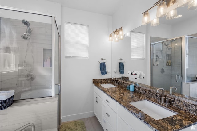 4898 N 10 E, Enoch, UT 84721 - full bathroom featuring double vanity, baseboards, a sink, and a stall shower