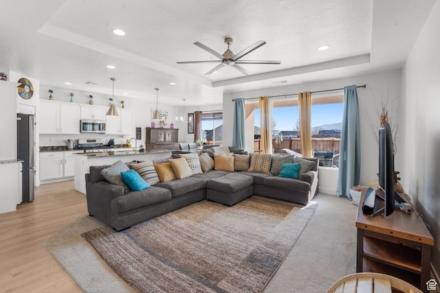 4898 N 10 E, Enoch, UT 84721 - living room with light wood-style floors, a raised ceiling, recessed lighting, and a ceiling fan