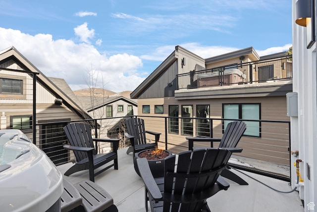 view of patio / terrace featuring a fire pit and a balcony