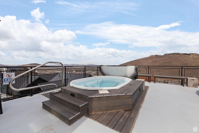 wooden terrace featuring a covered hot tub
