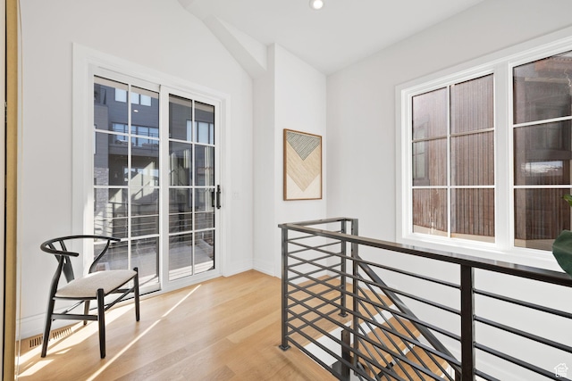 hallway with wood finished floors, baseboards, an upstairs landing, and recessed lighting
