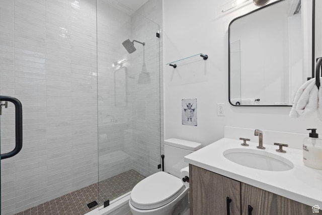 full bathroom with toilet, a shower stall, and vanity
