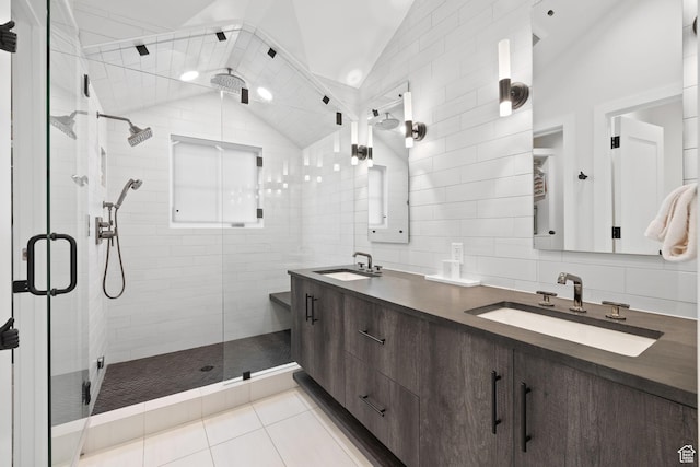 full bath featuring a shower stall, a sink, and vaulted ceiling