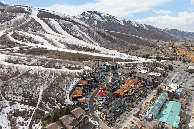 snowy aerial view with a mountain view