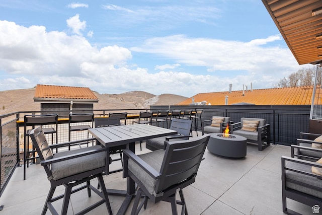 view of patio / terrace with a fire pit and outdoor dining area