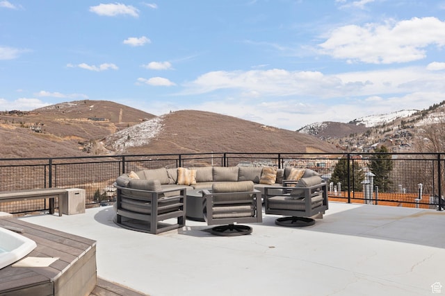 view of patio with a mountain view and an outdoor living space