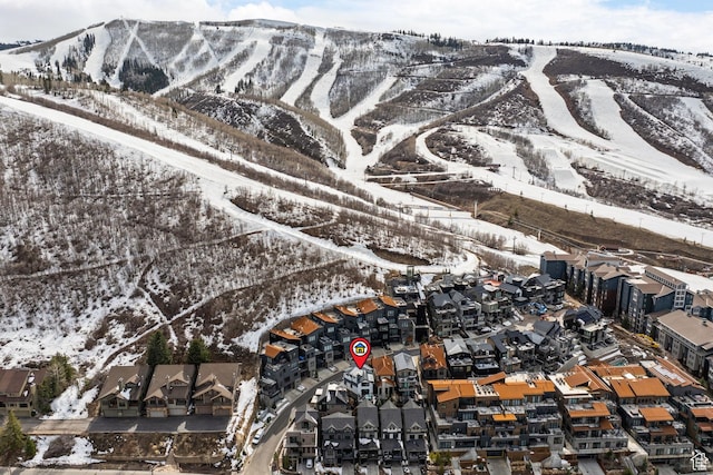 snowy aerial view featuring a mountain view