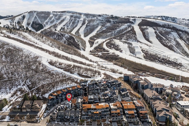 snowy aerial view featuring a mountain view