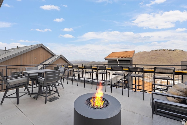 view of patio with outdoor dining area and a fire pit