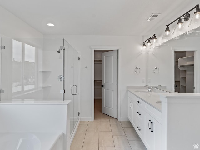 162 N Mia Cv Unit 16, Saratoga Springs, UT 84045 - bathroom featuring a walk in closet, a shower stall, tile patterned floors, double vanity, and recessed lighting