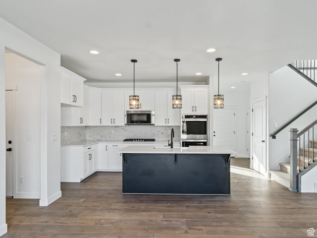 162 N Mia Cv Unit 16, Saratoga Springs, UT 84045 - kitchen featuring appliances with stainless steel finishes, white cabinetry, decorative backsplash, and recessed lighting