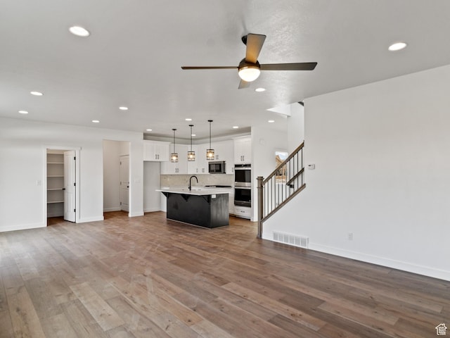 162 N Mia Cv Unit 16, Saratoga Springs, UT 84045 - unfurnished living room with a sink, recessed lighting, a ceiling fan, baseboards, and stairs