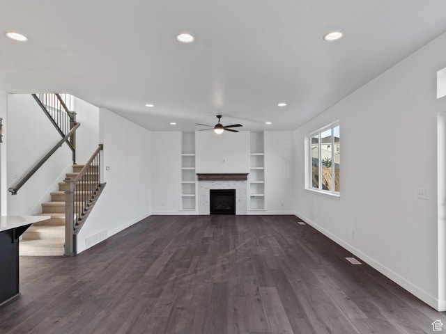 162 N Mia Cv Unit 16, Saratoga Springs, UT 84045 - unfurnished living room with baseboards, ceiling fan, stairway, built in shelves, and dark wood finished floors