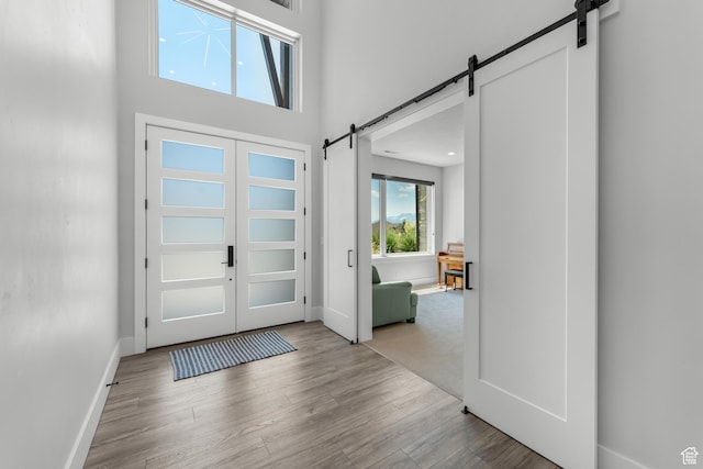 3131 E Lindsay Spring Rd, Heber City, UT 84032 - foyer entrance featuring a towering ceiling, wood finished floors, baseboards, and a barn door