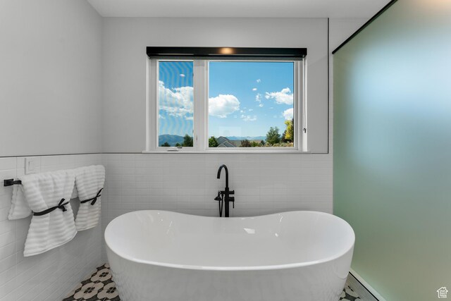 3131 E Lindsay Spring Rd, Heber City, UT 84032 - bathroom featuring tile walls, a freestanding tub, and a baseboard heating unit