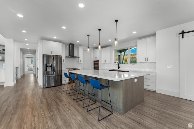 3131 E Lindsay Spring Rd, Heber City, UT 84032 - kitchen with backsplash, a large island, appliances with stainless steel finishes, and wall chimney exhaust hood