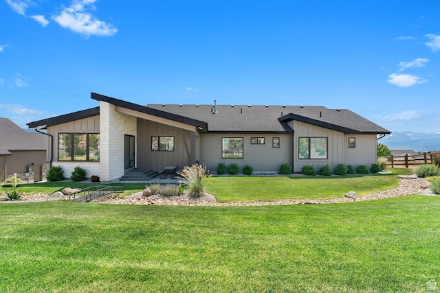 3131 E Lindsay Spring Rd, Heber City, UT 84032 - back of house featuring board and batten siding, fence, a lawn, and roof with shingles